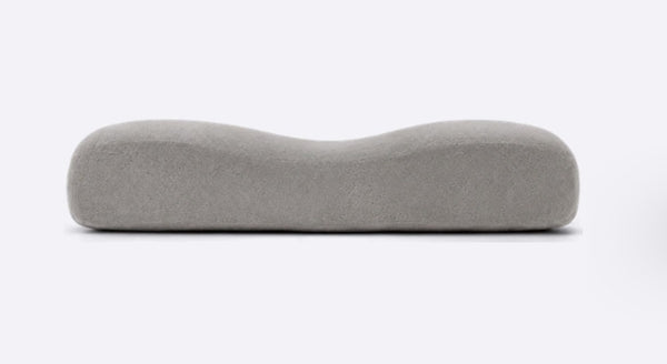 A flat grey memory foam pillow of the kind sold in stores