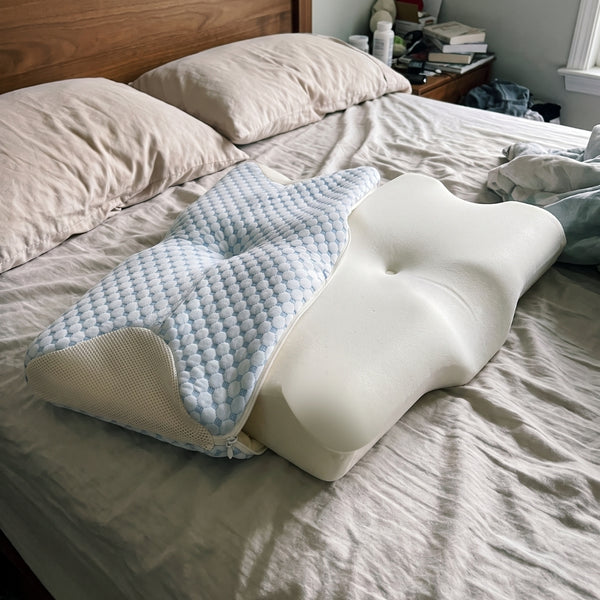 The Serenium Relief Pillow beside its foam core with the cover removed