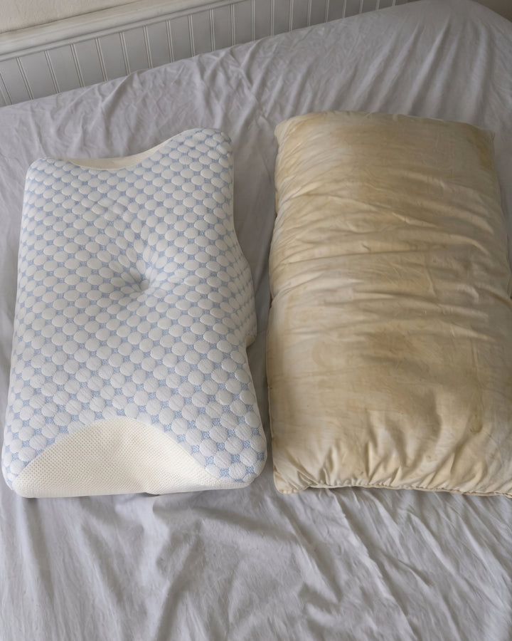 The Serenium Relief Pillow beside a flattened old pillow